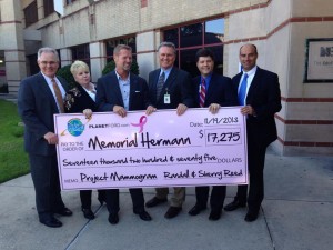 Left to right: Chuck Kramer, GM; Kristi Williams, Community Relations; Randall Reed, CEO of World Class Automotive present a check to Memorial Hermann Hospital.